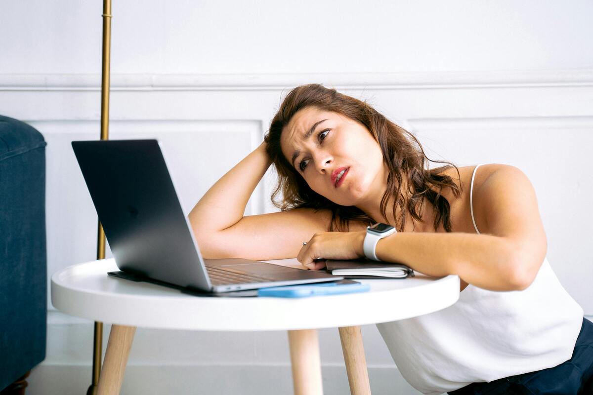 bored woman staring at a laptop, how to make work go by faster