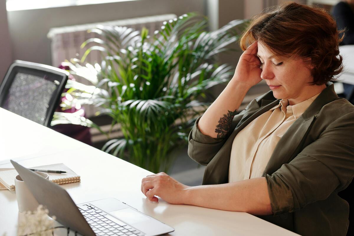bored woman sitting at a desk, how to make work go by faster