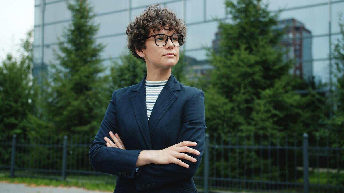 confident professional standing outdoors, career break meaning