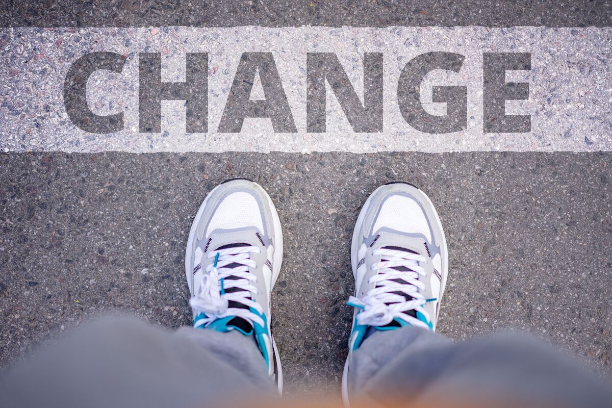 Close-up of sneakers on street with 'Change' text, career change cv