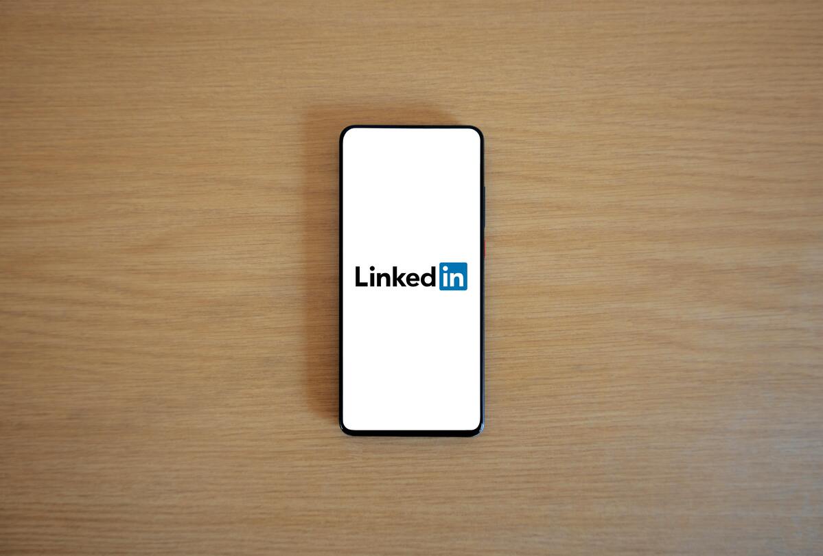 LinkedIn logo on smartphone screen, LinkedIn Open to Work feature guide