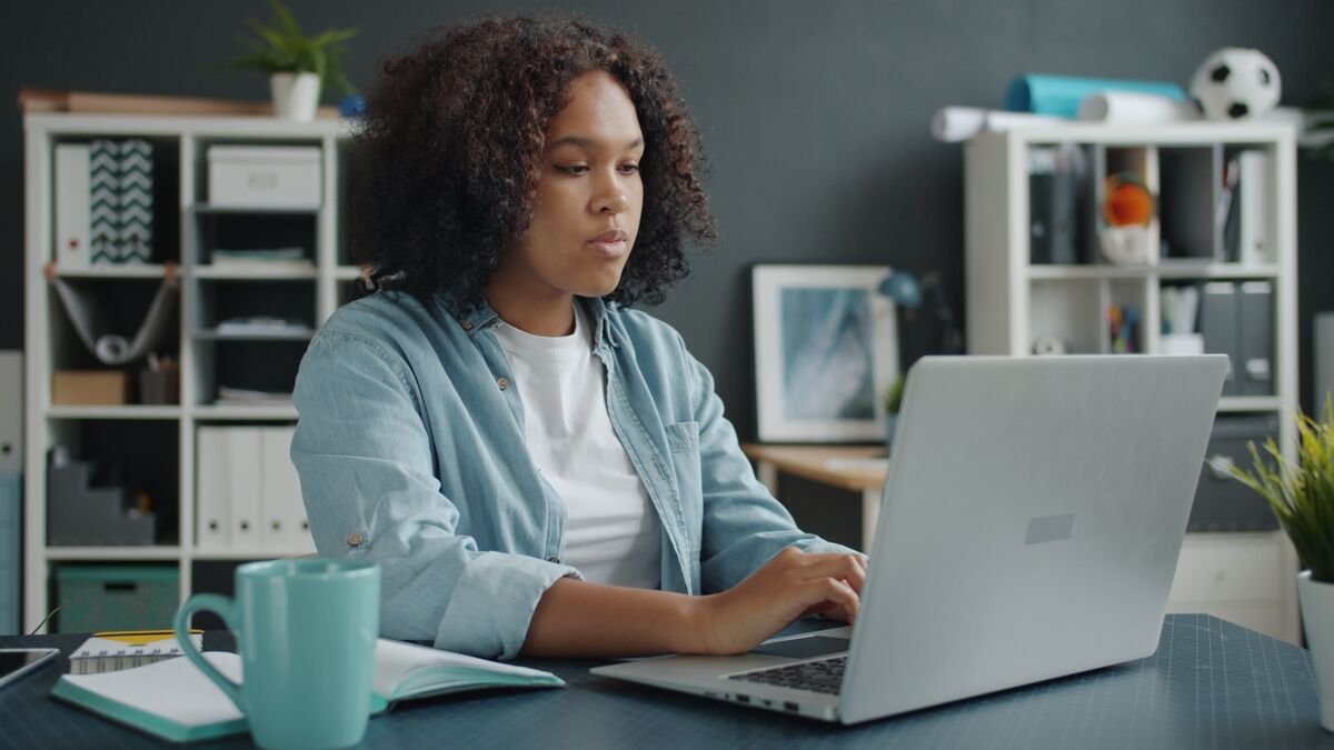 woman typing on a laptop, SMART goals for project managers