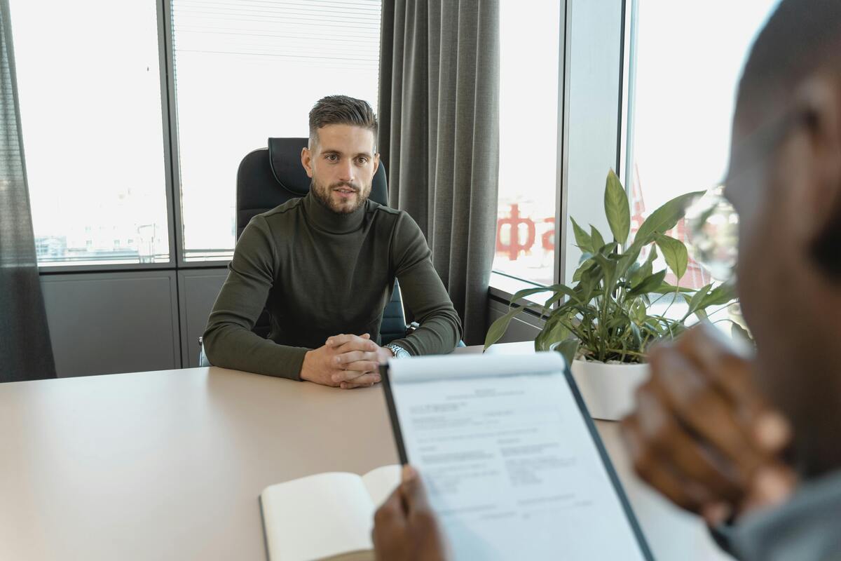 Candidate in a job interview being asked about their biggest weakness, representing how to answer the common ‘What are your weaknesses?’ interview question in UK interviews.